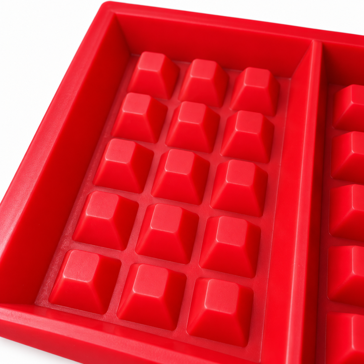 Close-up of the red waffle mould surface and five-by-three raised block pattern