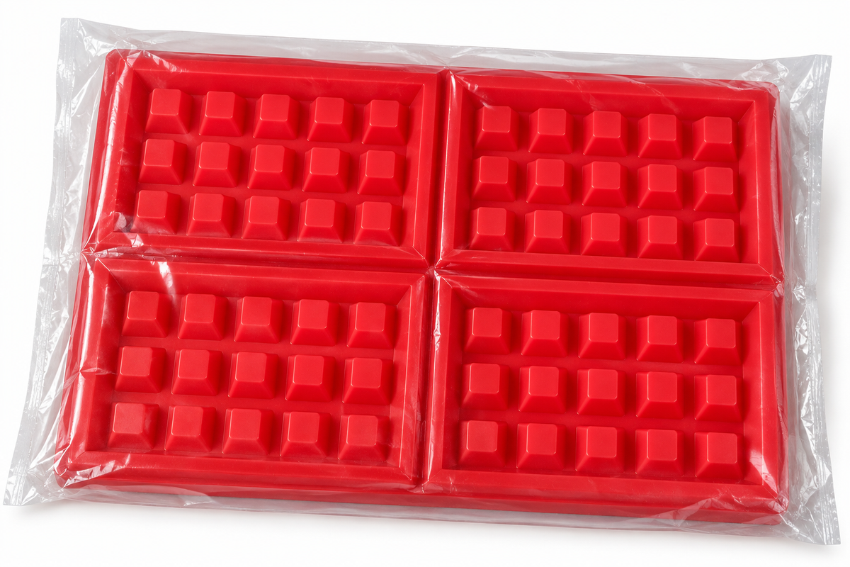 Four-cavity red waffle candle mould in clear protective packaging