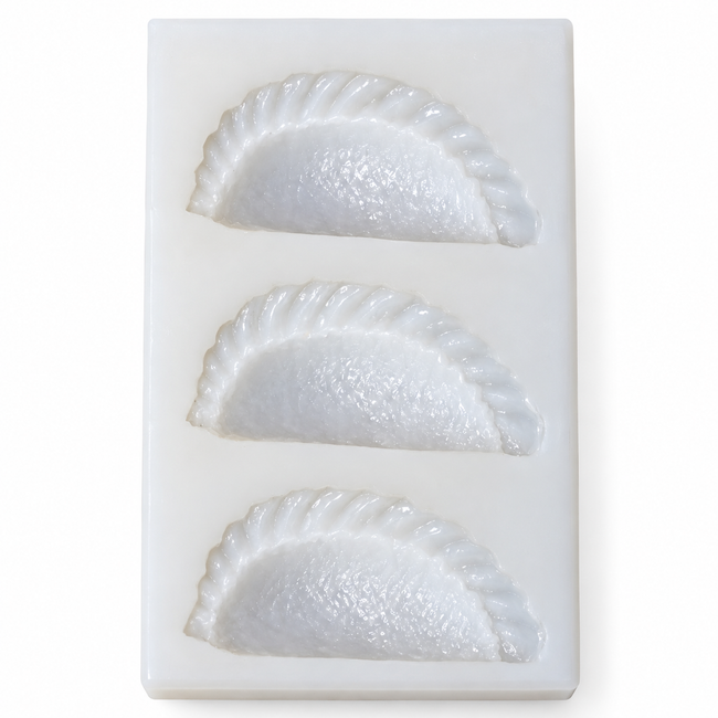 Top view of three crescent gujiya cavities in a thick white silicone candle mould