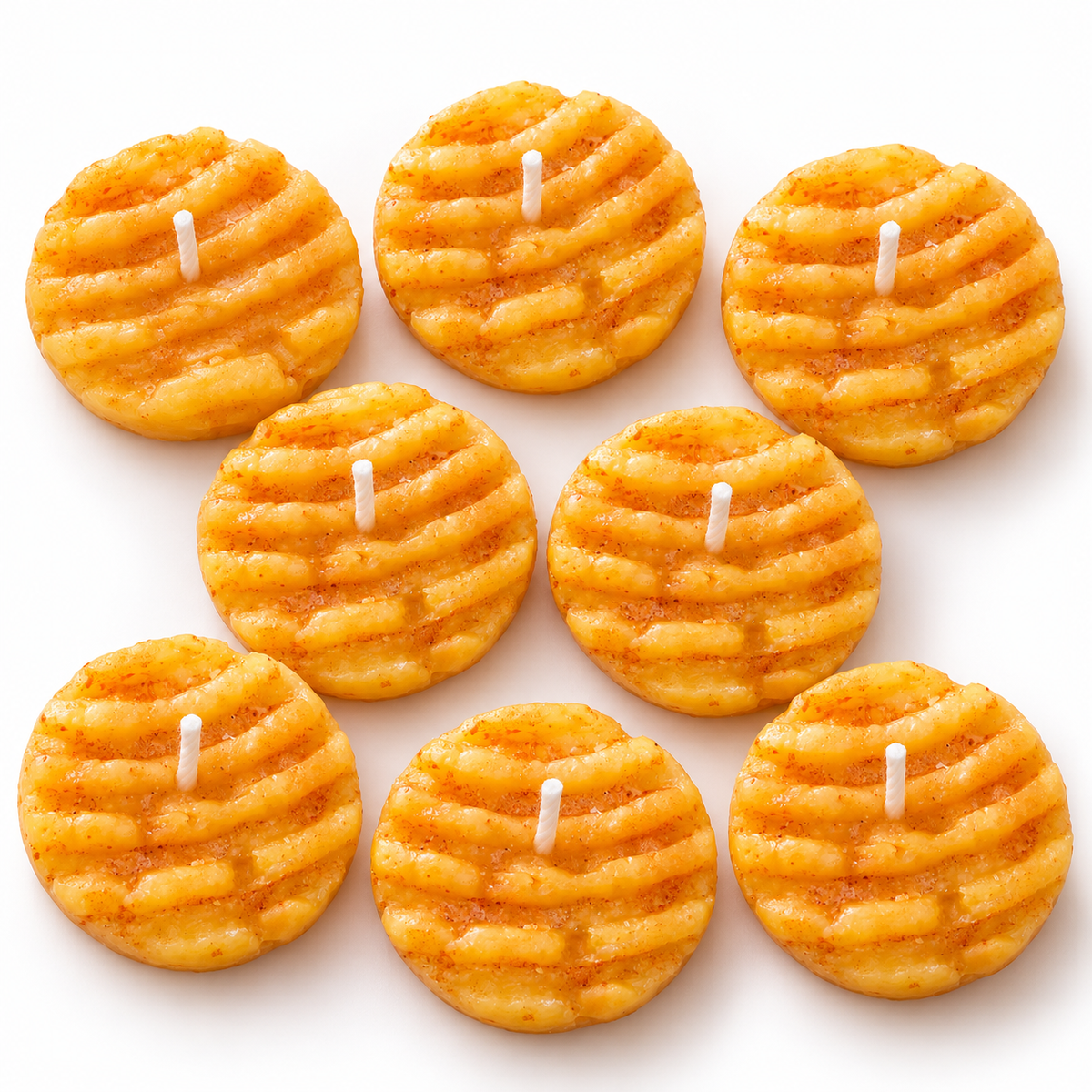 Lume & Co. butter biscuit scented candles pack of 8, golden ridged biscuit shaped candles with centred cotton wicks on white background