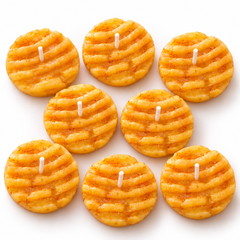 Lume & Co. butter biscuit scented candles pack of 8, golden ridged biscuit shaped candles with centred cotton wicks on white background