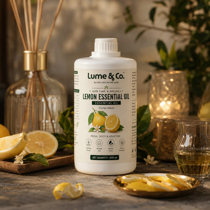 Lemon essential oil bottle beside diffuser reeds, fresh lemons and warm home fragrance decor