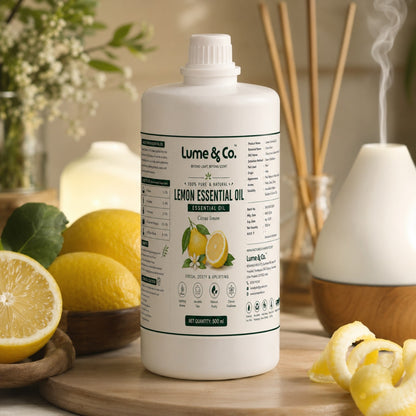 Lemon essential oil 500 ml bottle near aroma diffuser and lemon peels for home fragrance use