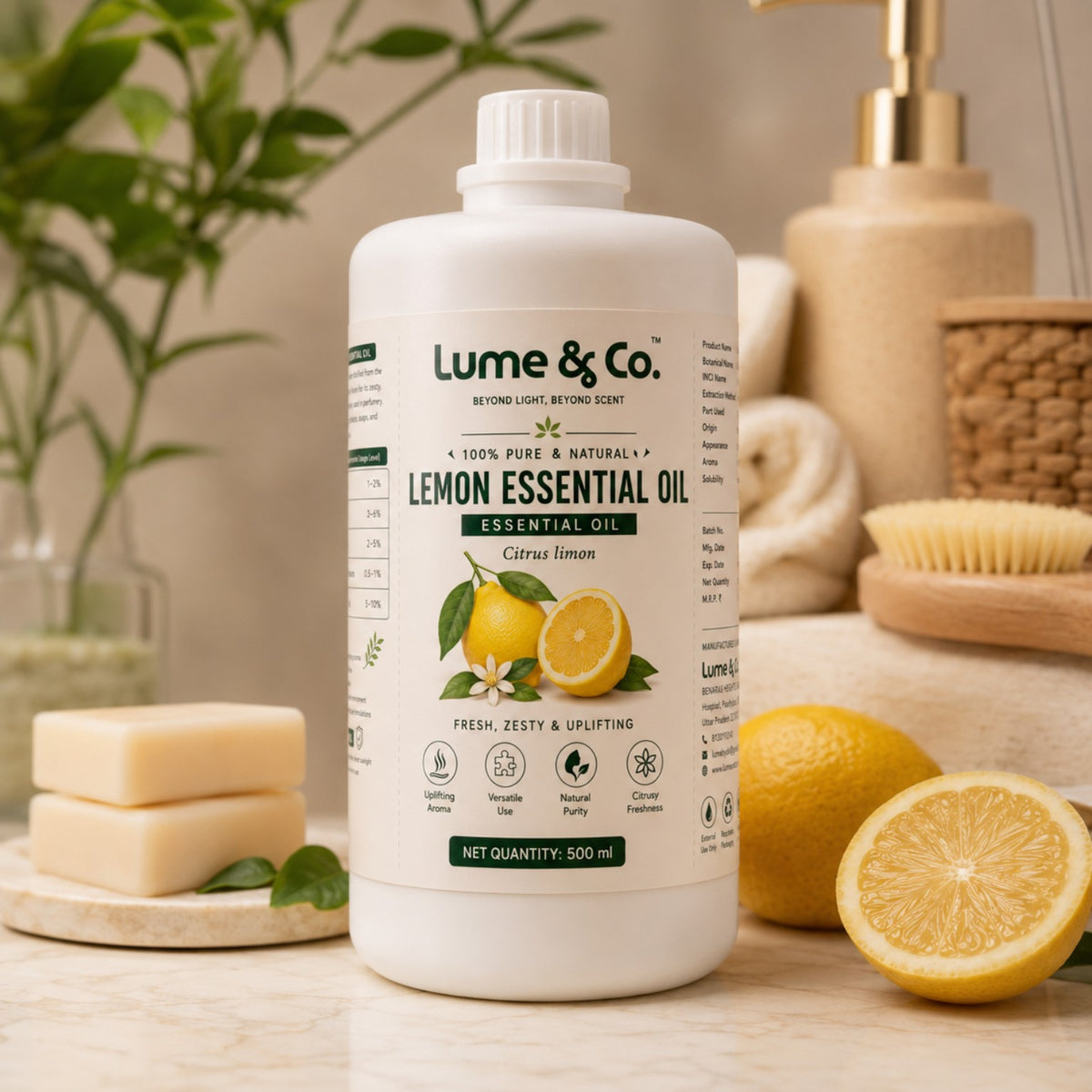 Lemon essential oil bottle with soap bars and fresh lemons for soap making and personal care formulations