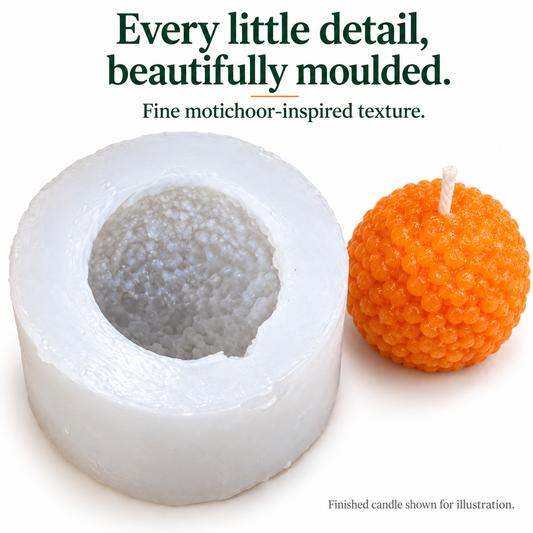 Close-up of fine boondi texture in the silicone laddu mould and finished orange candle