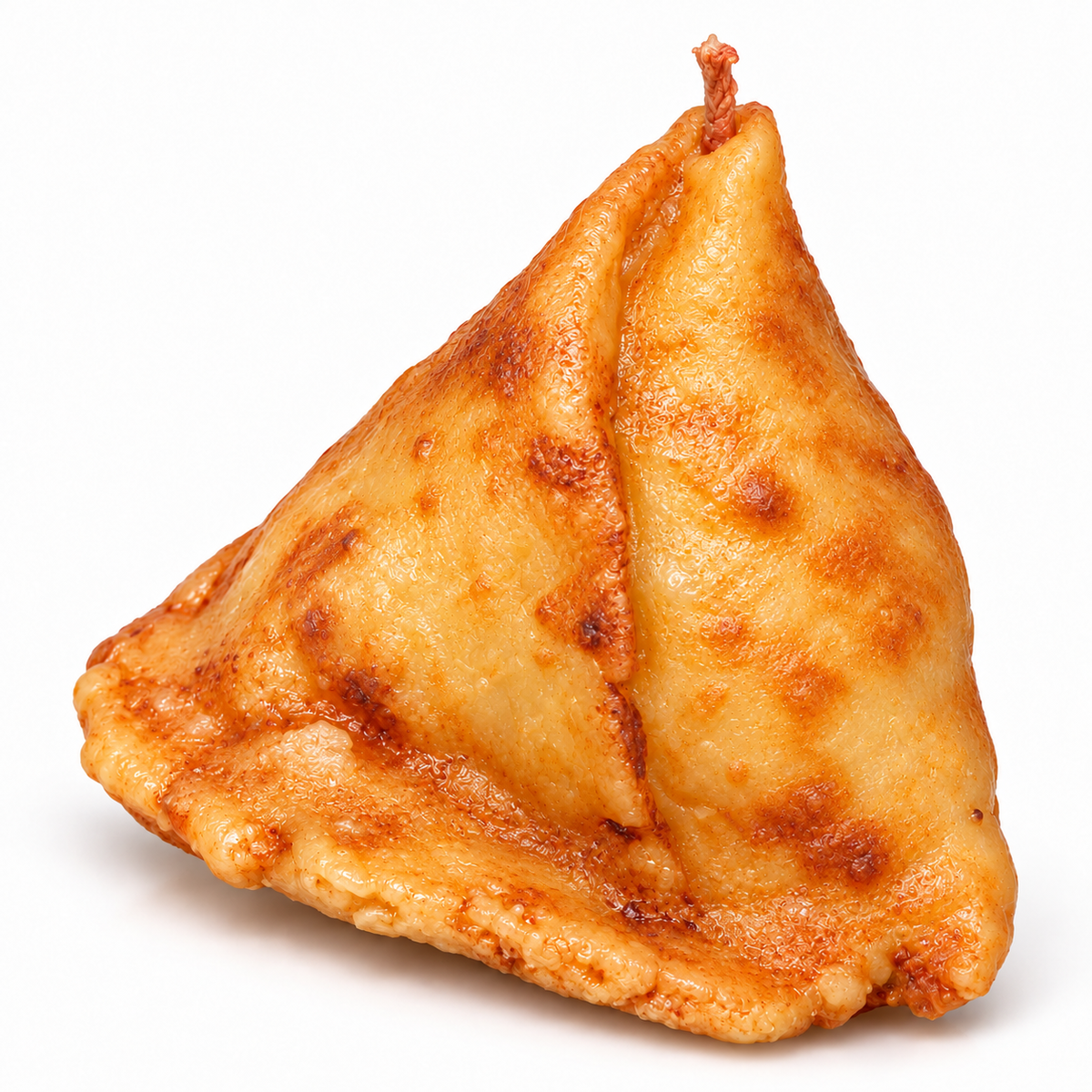 Realistic handmade golden samosa novelty candle by Lume & Co. on white background