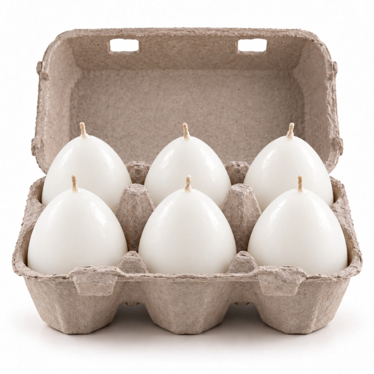 Pack of six white egg novelty candles, arranged in grey six-compartment cardboard egg carton, studio product image