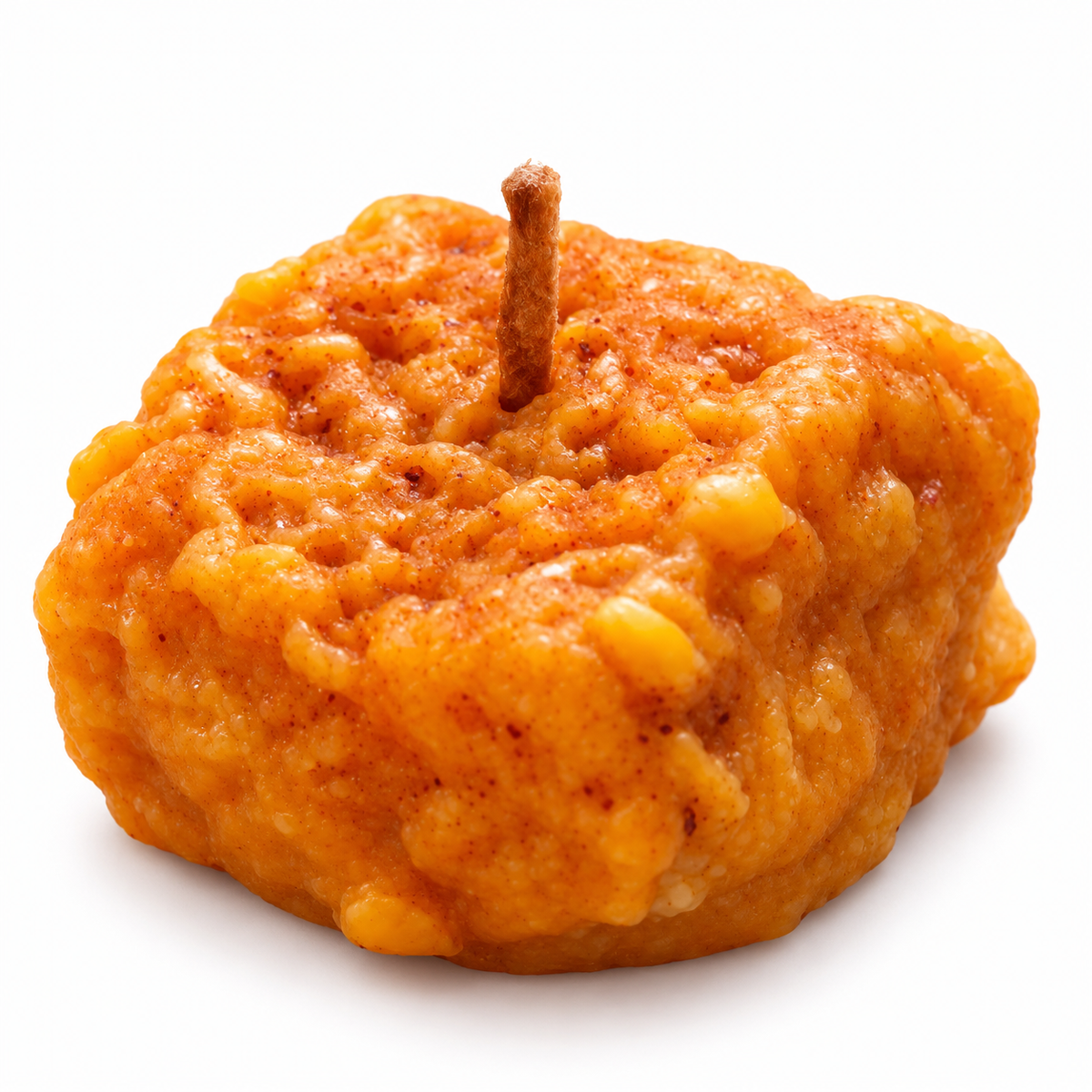 Closeup white-background listing photo of orange Dodha Barfi candle
