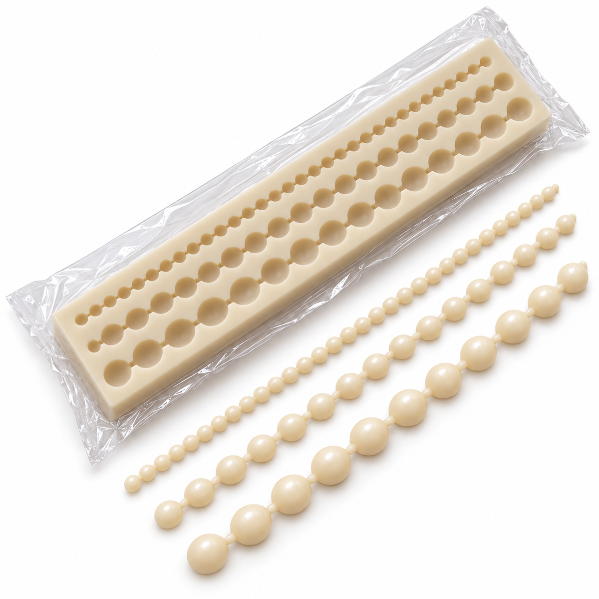 Packaged ivory silicone pearl mould beside illustrative wax pearl strands