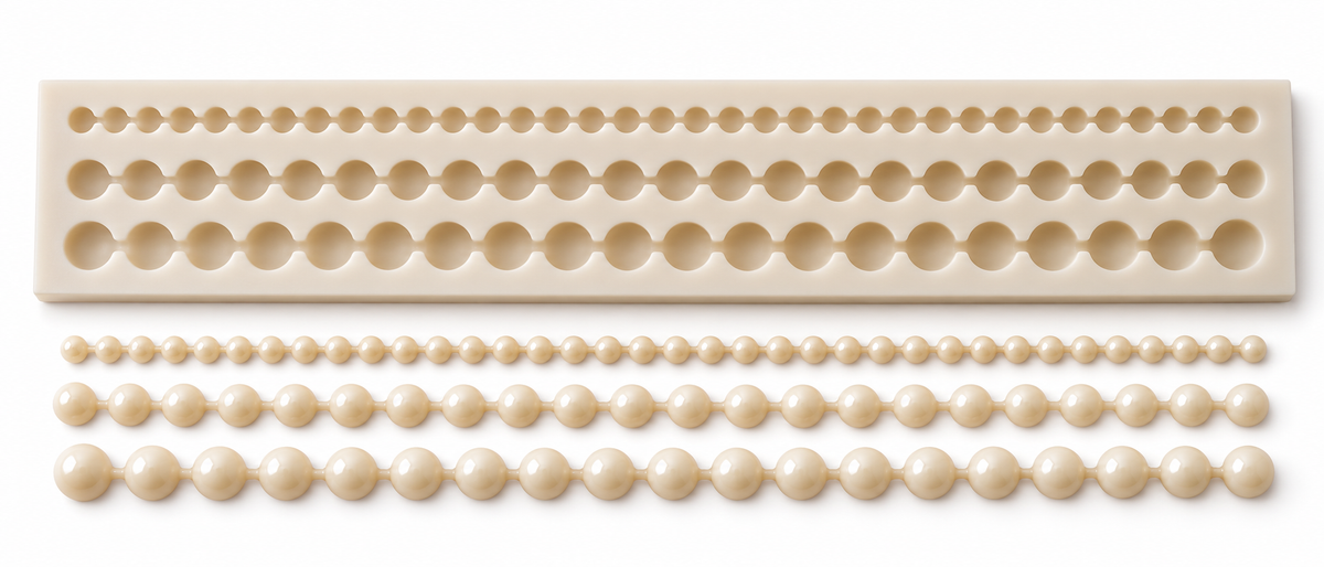 Top view of three pearl mould rows with illustrative wax bead strands in three sizes