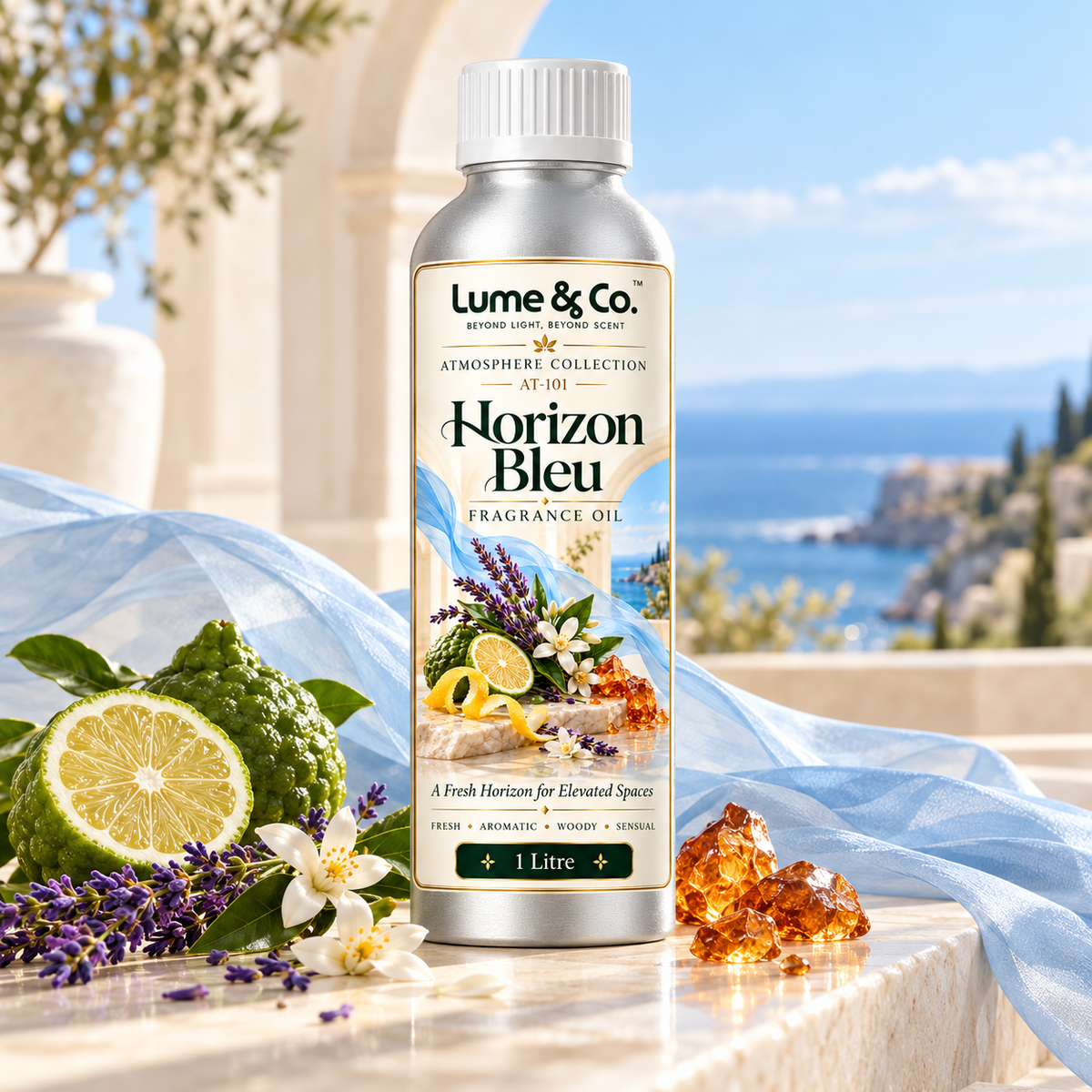 A 1 litre bottle of Lumé & Co. Horizon Bleu fragrance oil stands on a stone ledge with citrus, lavender, amber crystals, and blue fabric, set against a sunny coastal Mediterranean background.